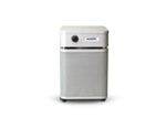 Austin Air HealthMate Junior HM200 Air Purifier with True HEPA Filter for Small Rooms on display in a cozy bedroom setting.