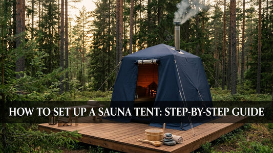 Fully assembled navy canvas sauna tent on a wooden deck with chimney pipe and sauna accessories at golden hour