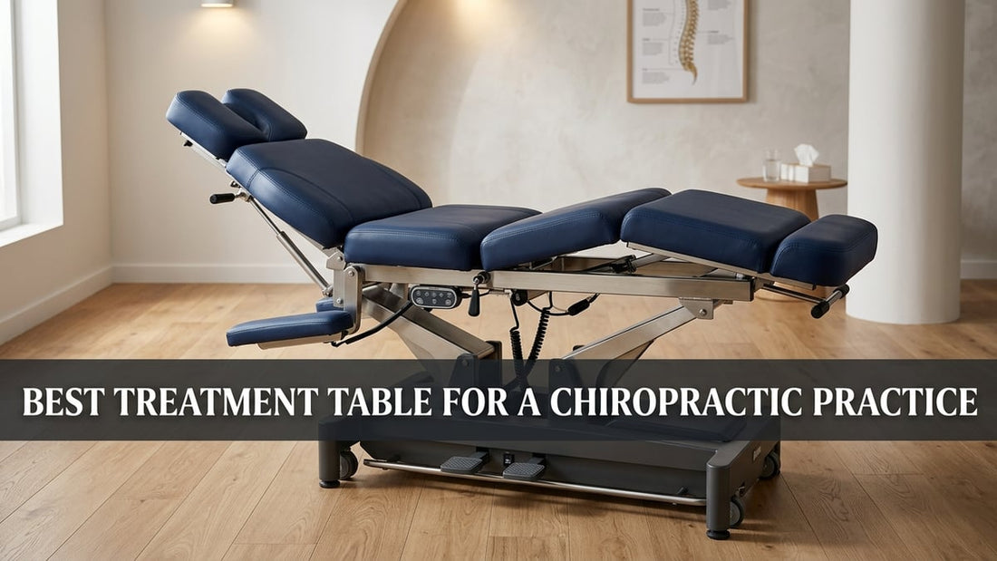 Premium navy-blue upholstered chiropractic treatment table with polished steel frame in a minimalist clinical room